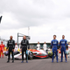 Formula 1 drivers gather around a model of the new F1 car.